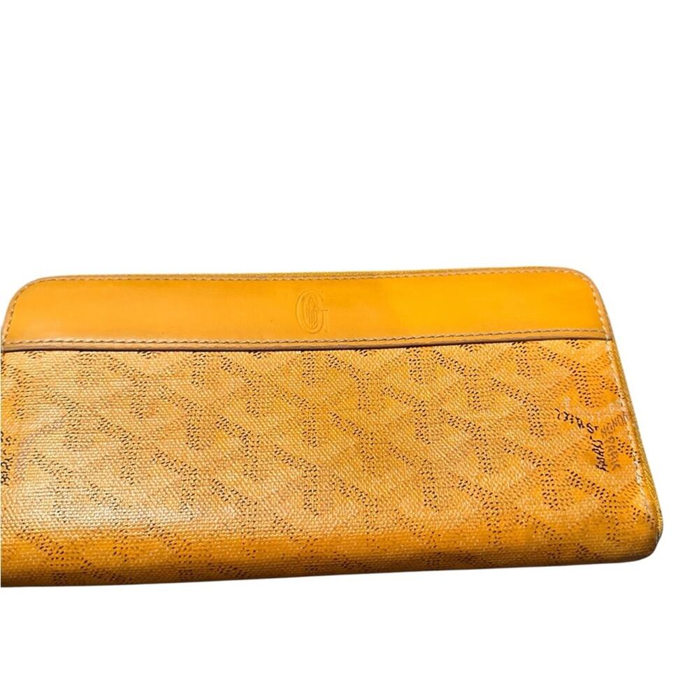 Goyard Matignon zip-around wallet in yellow orange Goyardine canvas.